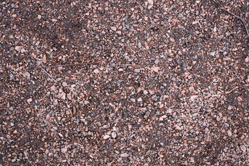 Close-up view of rocks and gravel on the ground, perfect for use in nature photography, landscape designs or still life compositions.