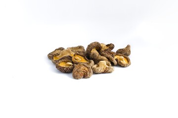 A sophisticated view of dried shiitake mushrooms on a white background, revealing their natural, rustic charm.