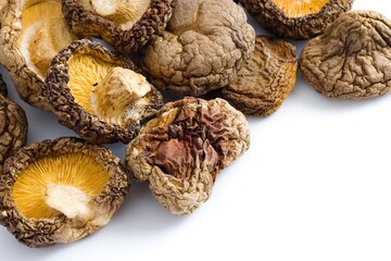 A classic composition of dried shiitake mushrooms on white, showcasing their intricate texture and rich flavor.