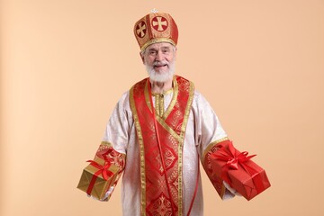Fototapeta premium Saint Nicholas with gifts on beige background