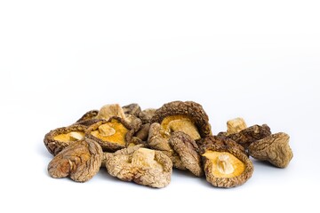 A classic composition of dried shiitake mushrooms on white, showcasing their intricate texture and rich flavor.