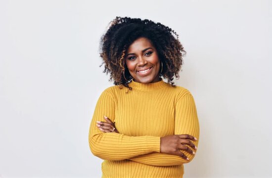 Portrait of a beautiful black woman smiling with arms crossed