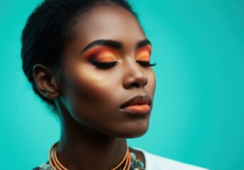 Stunning woman with vibrant makeup and a serene expression against a teal background