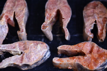 Sizzling meat on an outdoor grill, perfect for barbecues and picnics.