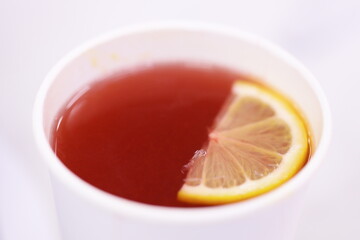 A warm cup of tea served with a slice of lemon, perfect for a cozy moment.