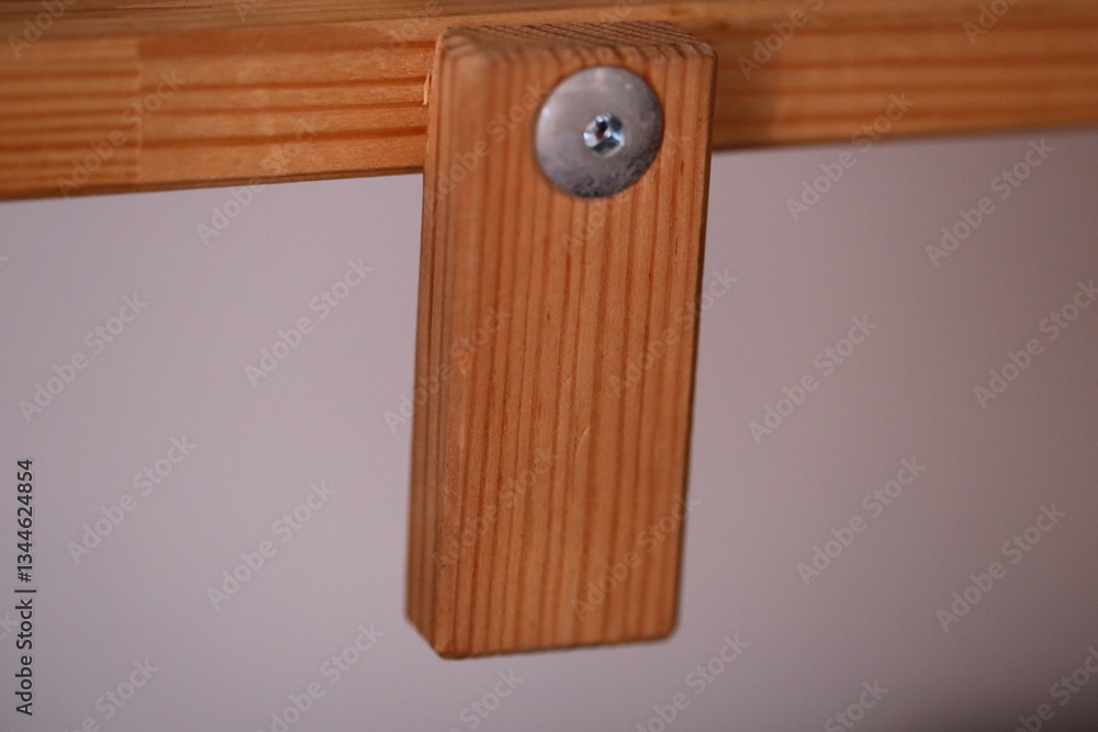 Poster close-up of a wooden object with a screw, suitable for diy or craft projects.