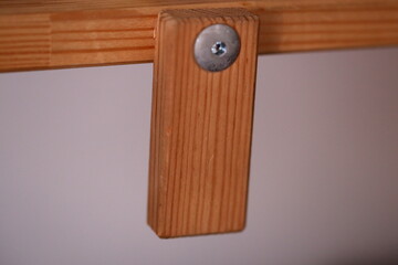 Close-up of a wooden object with a screw, suitable for DIY or craft projects.