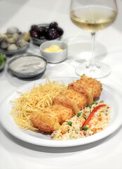 Fried and breaded prawns with Greek rice and French fries