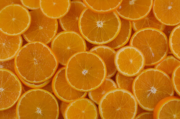 Vibrant orange slices arranged artfully on a wooden surface capturing the essence of freshness and...