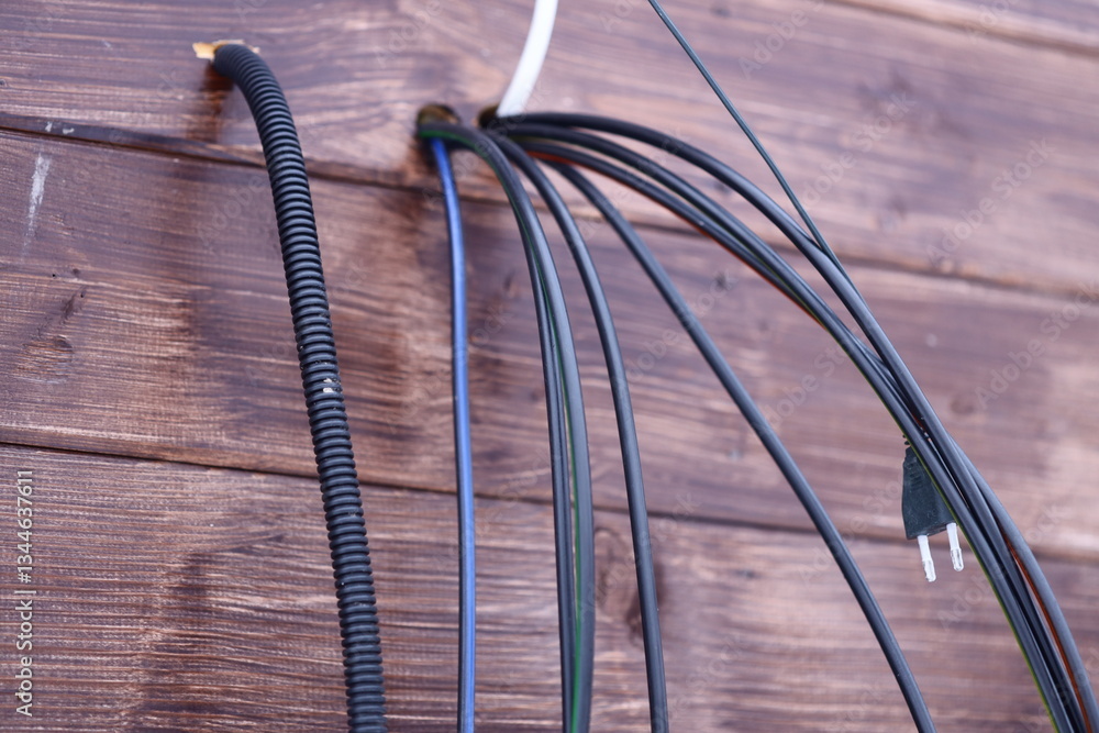 Aufkleber Close-up of wires attached to a wooden wall, suitable for use in DIY tutorials or electronics-related projects.