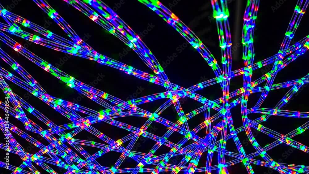 Poster fiber optic cables glowing with vibrant multicolored illumination, generating dynamic light patterns