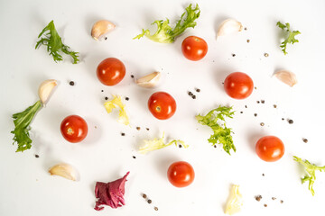 Ingredients and spices on white background. Tomatoes, garlic, fresh salad mix and pepper. Top view. 