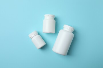 White bottles on blue background, top view