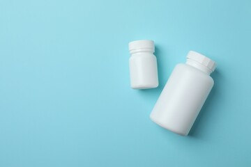 White bottles on blue background, top view
