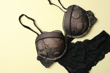 Flat lay with women romantic underwear on beige background, top view