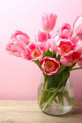 Beautiful bouquet of fresh tulips in the vase on the table