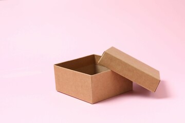 Open cardboard box on pink background