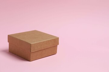 Cardboard box on pink background