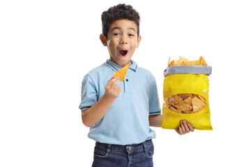 Excited boy eating crisps and smiling