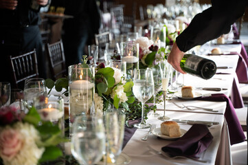 Champagne is poured at an elegantly decorated wedding reception table