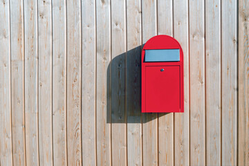 red mailbox on a wall