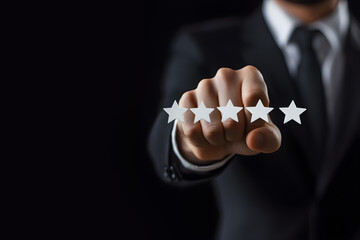 A businessman in a dark suit chooses the number of stars in the service quality rating in an online application or in an institution on a black background. Concept of Customer satisfaction survey