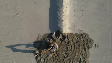 Bulldozer in Versilia, removal of storm surge protection, aerial video documentation.