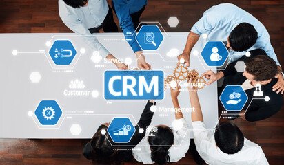 A diverse team collaborating on CRM strategies using modern technology. Visual symbols illustrate workflow and management tools for enhanced customer engagement and business growth. Amity