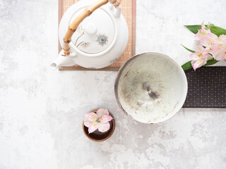 Traditional asian tea ceremony set with teapot and pink alstroemeria flowers