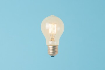 Illuminated bulb on a light blue background