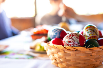 Decorated easter eggs basket on a the festive table.