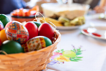 Decorated easter eggs basket on a the festive table.