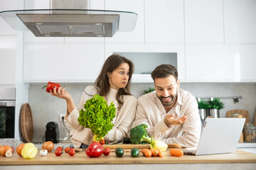 The image captures an engaging cooking session between partners filled with laughter, fresh...