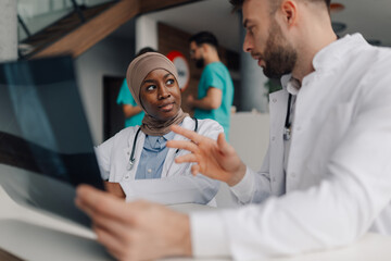 Doctors examining radiography during medical consultation in hospital