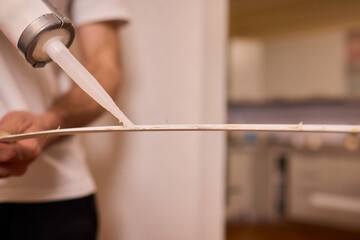 Applying adhesive to flexible material demands skill for a lasting, strong bond