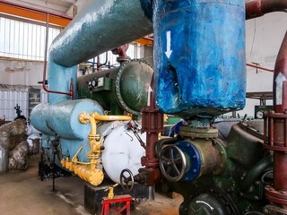 A complex, vintage air compression unit showcases its intricate design with vibrant colors and...
