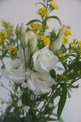 Bouquet of white Eustoma, commonly known as lisianthus or prairie gentian and Solidago, commonly...