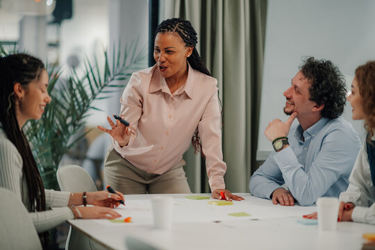 Diverse team engaging in creative meeting discussion - Powered by Adobe