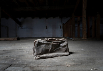 Old suitcase abandoned on the attic floor