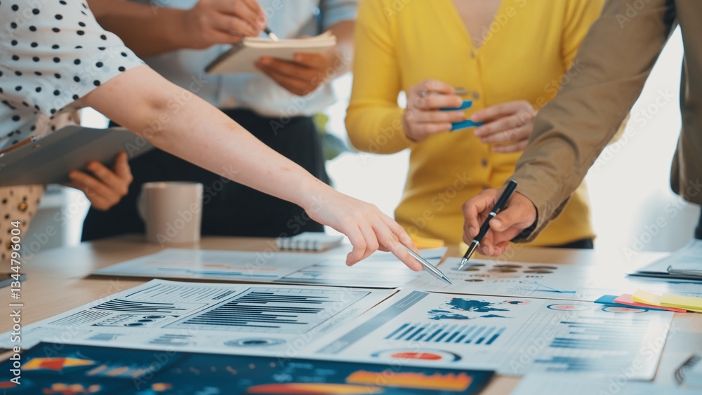 Poster a dynamic business meeting showcasing professionals collaboratively analyzing charts and data on a t
