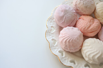 Airy Russian marshmallow dessert zephyr. Meringue dessert on a white plate, copy space