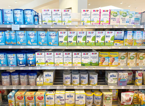 Variety of baby formula on supermarket shelves with organic and non-organic options