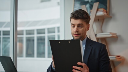 Professional consultant reading document with woman client at office closeup.
