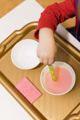 Child practicing fine motor skills