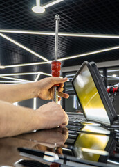 Removal of dents without painting. PDR technology for car body repair. PDR. The mechanic at the auto shop with tools to repair dents in car body. Body repair close-up.