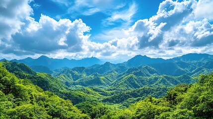 Obraz premium Scenic View of Lush Green Mountains Under Blue Sky with Clouds