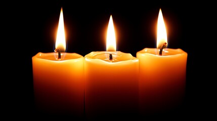 Three lit candles brightly glowing against a dark backdrop