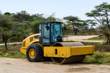 Yellow road roller at construction site