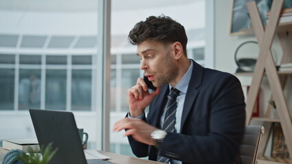 Worried manager calling cellphone discussing business report in office closeup