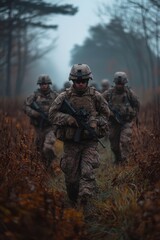 Soldiers patrol foggy forest area, maintaining security and vigilance during a military exercise in autumn